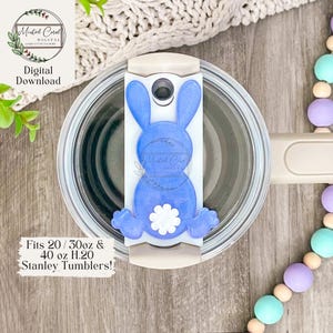 May include: A blue bunny-shaped silicone lid for a 20, 30, or 40 ounce Stanley tumbler. The lid has a white flower on the back. Fits 20/30oz & 40 oz H.20 Stanley Tumblers!