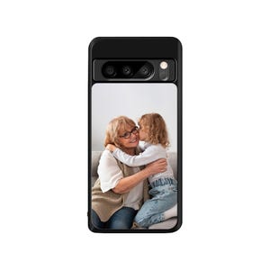 May include: A black phone case with a photo of a grandmother and granddaughter hugging. The grandmother is wearing glasses and a brown sweater. The granddaughter is wearing a blue shirt and jeans.