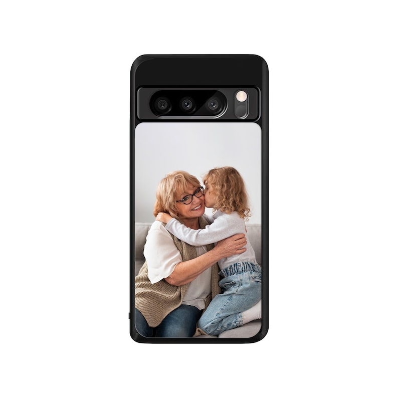 May include: A black phone case with a photo of a grandmother and granddaughter hugging. The grandmother is wearing glasses and a brown sweater. The granddaughter is wearing a blue shirt and jeans.