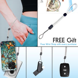 May include: A phone case with a colorful butterfly design. The case is attached to a white wrist strap. The strap is also shown attached to a car key and a small black case. The text "FREE Gift" and "Free Wrist Strap with every purchase" is displayed.