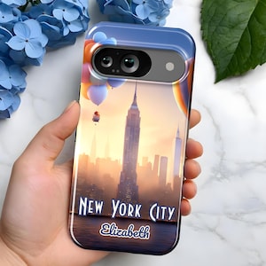 May include: A phone case with a colorful hot air balloon design and a cityscape of New York City. The case has a personalized name, "Elizabeth", printed on the bottom.
