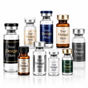 May include: A collection of nine glass vials with metallic caps in various sizes and colors, including clear, amber, and frosted glass. Each vial features a rectangular label with the printed text Your Design Here in gold or black lettering.