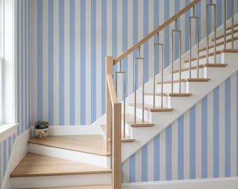May include: A staircase with light wood treads and white risers, featuring a metal and wood railing. The walls are covered in vertical light blue and white striped wallpaper. A small, round, patterned ceramic planter sits on the bottom step.