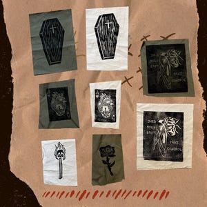 May include: A collection of small, fabric patches with black and white linocut designs. The patches feature images of a coffin, a heart, a match, a rose, and a cicada with the text "Shed Your Past Take Control."
