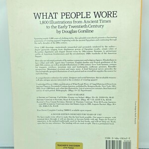 May include: A book cover titled "WHAT PEOPLE WORE" with text and illustrations. The book, by Douglas Gorsline, features 1,800 illustrations from ancient times to the early 20th century. The cover is white with black text.