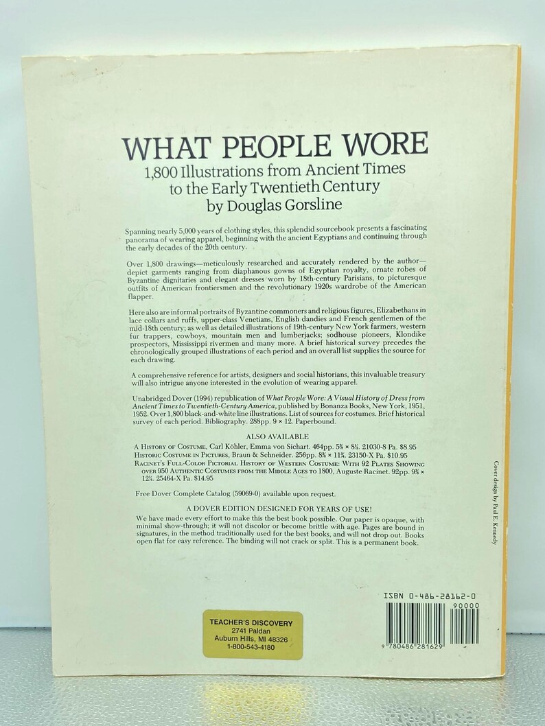 May include: A book cover titled "WHAT PEOPLE WORE" with text and illustrations. The book, by Douglas Gorsline, features 1,800 illustrations from ancient times to the early 20th century. The cover is white with black text.