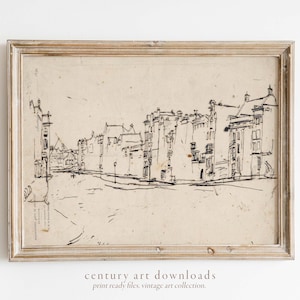 May include: A black and white ink drawing of a city street with buildings on both sides. The drawing is framed in a light wood frame.