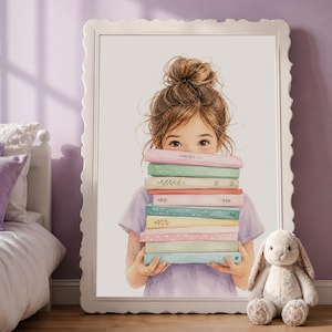 May include: Watercolor print of a young person holding a stack of colorful books. The books are pastel shades of pink, green, and blue, with delicate floral and heart designs. The person is wearing a lavender shirt, and the print is framed in a white, scalloped edge frame.