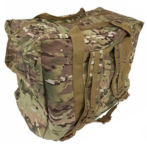 May include: A large, green and brown camouflage duffel bag with a brown shoulder strap and a brown backpack strap. The bag has a zippered closure and a large main compartment.