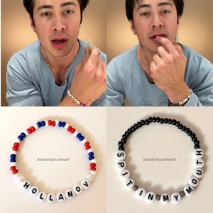 May include: Two beaded bracelets. One is red, white, and blue with the name "HOLLANOV". The other is black with the words "SPIT IN MY MOUTH". Both bracelets have the text "beadofyourheart".