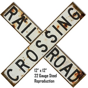 May include: A vintage-style, white metal railroad crossing sign with black lettering. The sign reads "RAILROAD CROSSING" and measures 12 inches by 12 inches. It is made of 22 gauge steel and is a reproduction.
