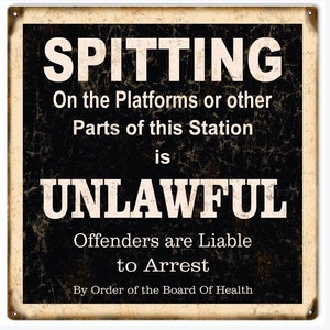 May include: A vintage-style metal sign with a black background and white text. The sign reads "SPITTING On the Platforms or other Parts of this Station is UNLAWFUL Offenders are Liable to Arrest By Order of the Board Of Health".
