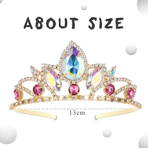 May include: A gold tiara with pink and iridescent gemstones. The tiara is 13 inches wide.