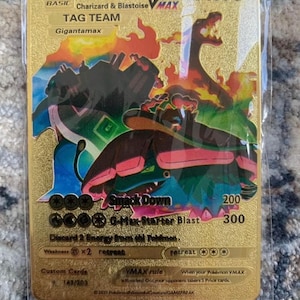 May include: A gold-colored Venusaur, Charizard & Blastoise VMAX Tag Team card. The card features Gigantamax artwork with the text "Smack Down" and "G-Max Starter Blast". The card is in a protective sleeve.