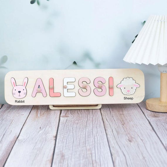 A $325 heirloom-grade multi-animal name puzzle that reads more like a sculptural nursery art piece than a toy — the kind of thing that gets passed down.
