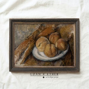 May include: A framed oil painting depicting a still life of peaches on a white plate. The peaches are arranged in a cluster, with some overlapping. The painting is set against a brown background, with a brown cloth draped over the table.