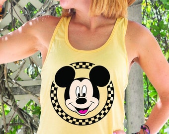 May include: A yellow tank top with a black and white checkered circle featuring Mickey Mouse's face.