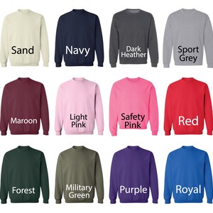 May include: A selection of 12 crewneck sweatshirts in various colors, including sand, navy, dark heather, sport grey, maroon, light pink, safety pink, red, forest, military green, purple, and royal blue.