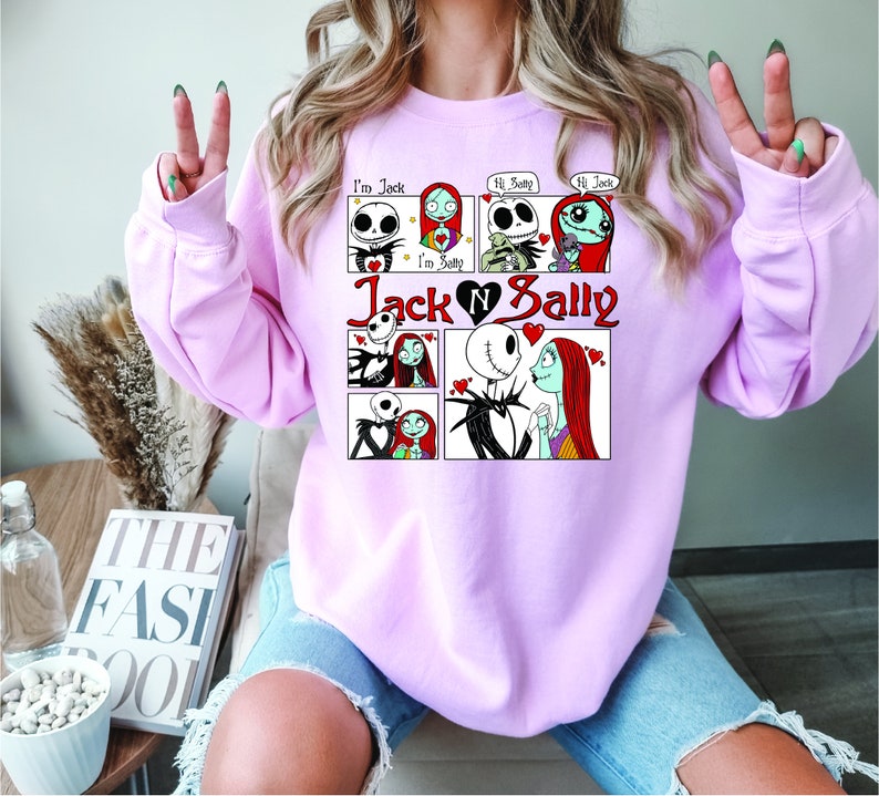 Puede incluir: Una sudadera rosa claro con un dise&ntilde;o de c&oacute;mic que presenta a Jack y Sally de The Nightmare Before Christmas. El dise&ntilde;o incluye el texto "I'm Jack", "Hi Sally" y "Jack & Sally" con gr&aacute;ficos de coraz&oacute;n. La sudadera es de cuello redondo.