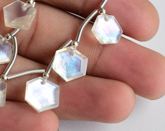 May include: A strand of iridescent white gemstone beads with a silver wire connector. The beads are faceted and have a hexagonal shape.