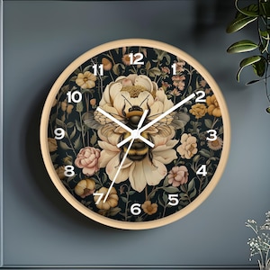 May include: A round wooden clock with a black background and floral design. The clock face features white Roman numerals and a bee in the center. The clock is 12 inches in diameter.