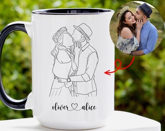 May include: White ceramic mug with a black handle and rim. The mug features a line drawing of a couple kissing, with the names "oliver" and "alice" below. A small photo of the couple is also included. The mug is a personalized gift.
