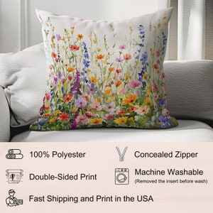 May include: A white throw pillow with a colorful floral print featuring a variety of flowers in shades of pink, red, orange, yellow, blue, and purple. The pillow has a concealed zipper and is made of 100% polyester. It is machine washable.