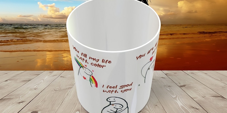 May include: White ceramic mug with a red and black illustration of a unicorn and the text "You fill my life with color". The mug also has the text "I feel good with you" and a black and white illustration of two people hugging.
