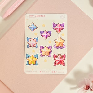 May include: A sheet of Star Guardian themed stickers featuring colorful stars with wings and floral accents. The sticker sheet includes the text "Star Guardian" and "Sticker Sheet".
