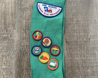 vintage Girl Scouts green sash with patches and pins