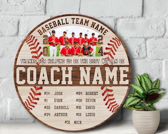 May include: A wooden baseball-themed sign with a team photo, the text "BASEBALL TEAM NAME", "THANKS FOR HELPING US BE THE BEST WE CAN BE", and "COACH NAME". The sign also lists player names and numbers.
