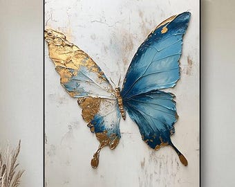 May include: A framed canvas print of a blue and gold butterfly with textured paint. The butterfly is set against a white background.