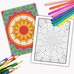 May include: Two mandala coloring pages, one with a colorful mandala design and the other with a black and white outline. The colorful mandala has a red, orange, and yellow color scheme. The pages are surrounded by colored pencils and markers.