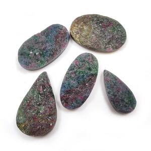 May include: Five oval and teardrop shaped gemstones with a green, pink, and blue mottled pattern.