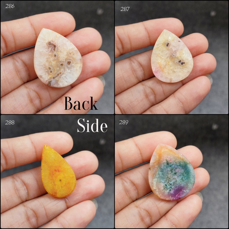 May include: Four agate cabochons in various colors and patterns. The cabochons are teardrop shaped and have a smooth, polished surface. The colors include white, pink, yellow, and green.
