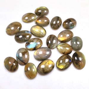 May include: A collection of 18 oval-shaped labradorite gemstones in various shades of green, brown, and gold with iridescent flashes.