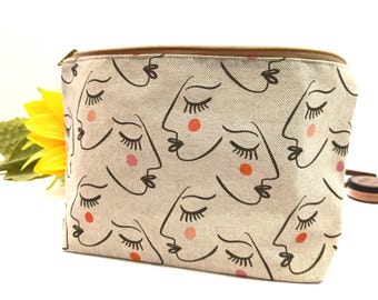 Neceser artesanal para mujer. Neceser de tela con estampado abstracto de rostro. Neceser de algodón con cremallera. Neceser forrado e impermeable.