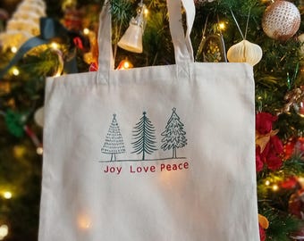 Bolsa de lona de algodón ecológica con bordado a máquina "Árbol de Navidad con alegría, paz y amor". Bolsa de regalo resistente, en tonos festivos rojo y verde.