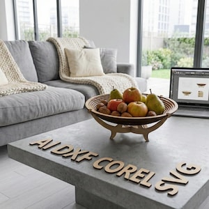 May include: A wooden fruit bowl filled with apples, pears, and walnuts sits on a concrete coffee table. A laptop displays a design, and the text "AI DXF COREL SVG" is on the table. A gray sofa with cream-colored pillows and a blanket is in the background.