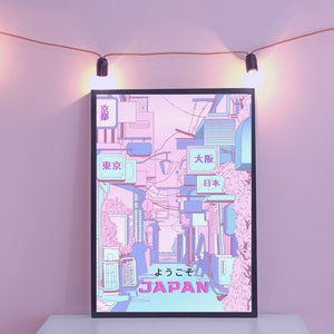 May include: A framed print of a Japanese city street scene with pink and blue buildings and the text "よっこそ JAPAN" in pink and blue lettering.