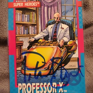 May include: A trading card featuring Professor X from the Super Heroes series. The card shows a bald man in a wheelchair, wearing a suit and tie. The card has a blue border with the text "PROFESSOR X" and a signature.