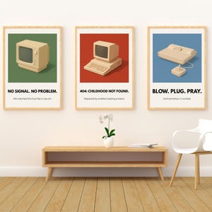 May include: Three framed art prints with retro computer and gaming console illustrations. The prints feature text: "NO SIGNAL. NO PROBLEM.", "404: CHILDHOOD NOT FOUND.", and "BLOW. PLUG. PRAY.". Each print has a different colored background: green, red, and blue.
