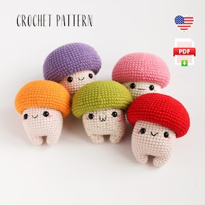 May include: A collection of five crocheted mushroom figures in various colours: orange, green, purple, pink, and red. Each mushroom has a smiling face. The words "CROCHET PATTERN" are at the top. A PDF download icon and an American flag are also visible.