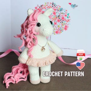 May include: Crochet pattern for a pink and white unicorn amigurumi doll wearing a pink dress and a pearl necklace. The doll has black eyes and a pink mane and tail.
