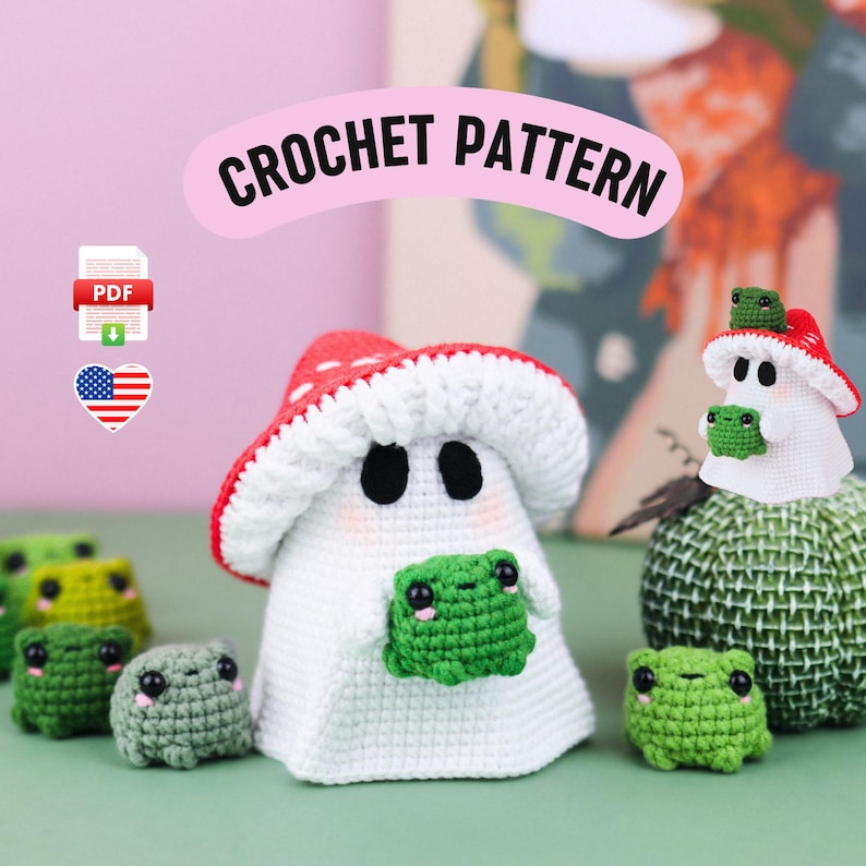 An adorable ghost wearing a red-spotted toadstool hat, cradling a tiny green frog in its hands. The ghost features black felt eyes, rosy embroidered cheeks, and a playful surprise—under its white cloak hides a hidden potato man! A whimsical handmade crochet creation full of sweet details. Perfect for Halloween decor.