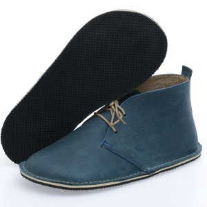 May include: Blue leather ankle boots with a lace-up closure and a rubber sole.