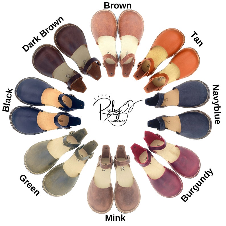 May include: A circle of 10 pairs of leather sandals in various colors, including black, brown, tan, green, navy blue, burgundy, and mink. The sandals have a simple design with a single strap across the foot and an ankle strap with a buckle. The sandals are arranged in a circle with the brand name "Ruby Handmade" in the center.