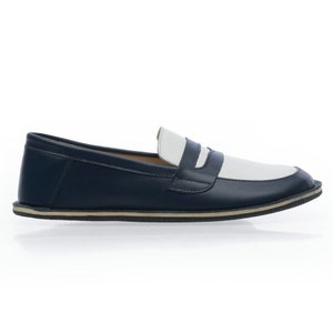 May include: A pair of blue and white leather loafers with a white rubber sole.