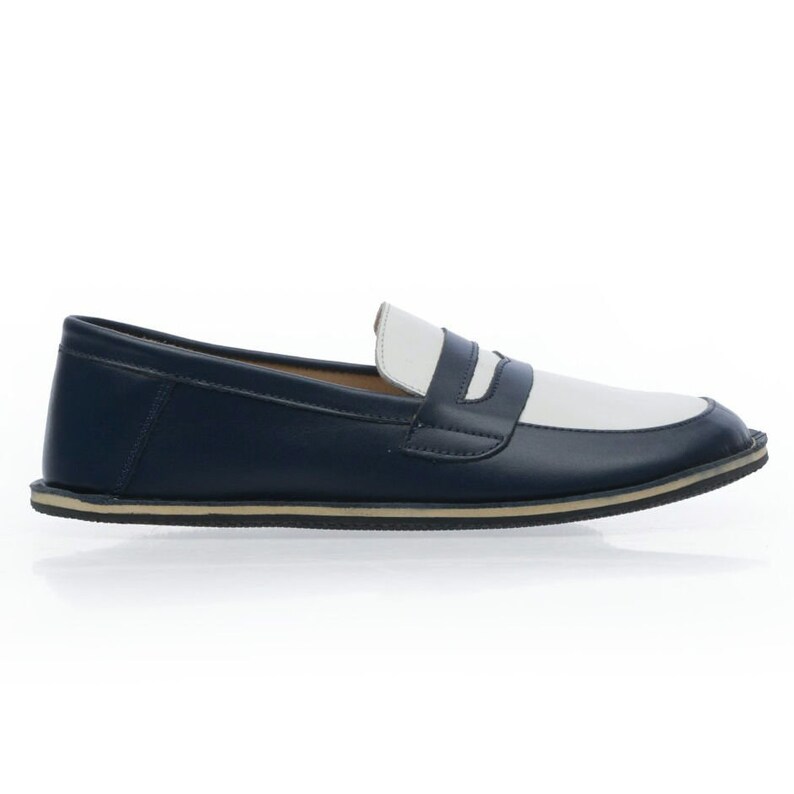 May include: A pair of blue and white leather loafers with a white rubber sole.