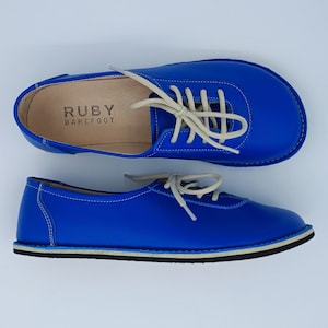 Ruby Blue minimalist barefoot handmade soft leather woman sneakers are 100% handmade from all sustainable natural materials. Ruby women casual sneakers not only have a rich story but also have a unique aesthetic quality, and comfort.